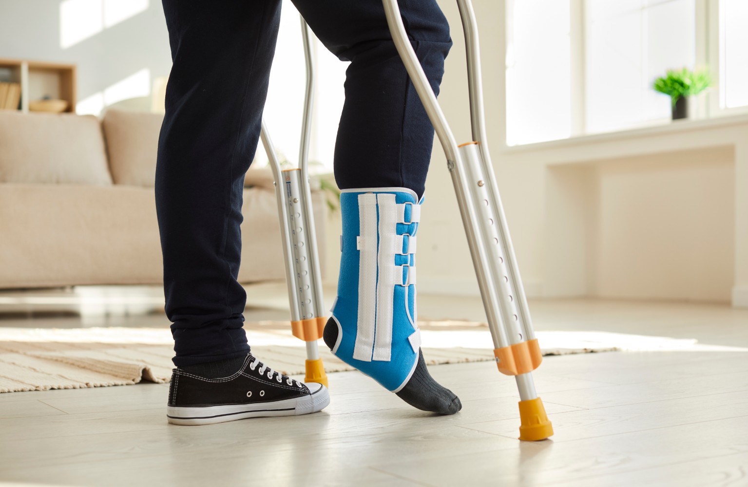 Unwell man with bandage on leg walk on crutches